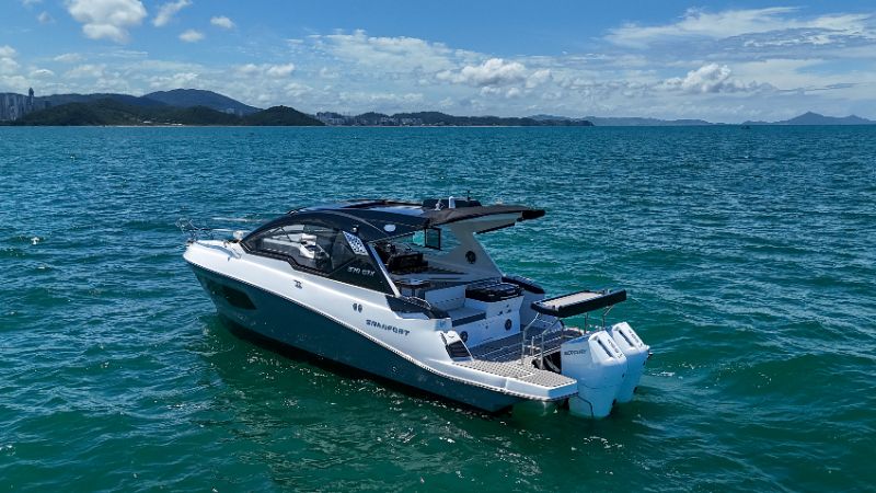 Premium boats docked at a sunny coats with clear blue skies and calm water