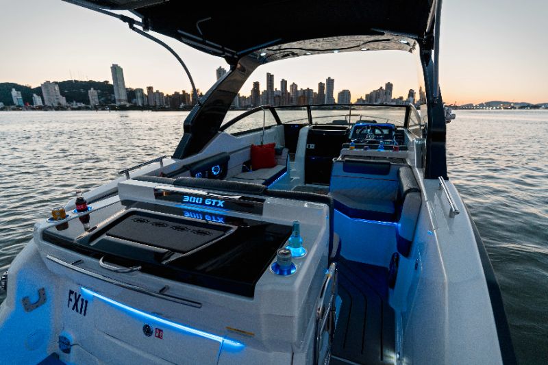 Six premium luxury boats lined up on a sparkling blue marina under clear sky, showing different sizes and Italian design influences